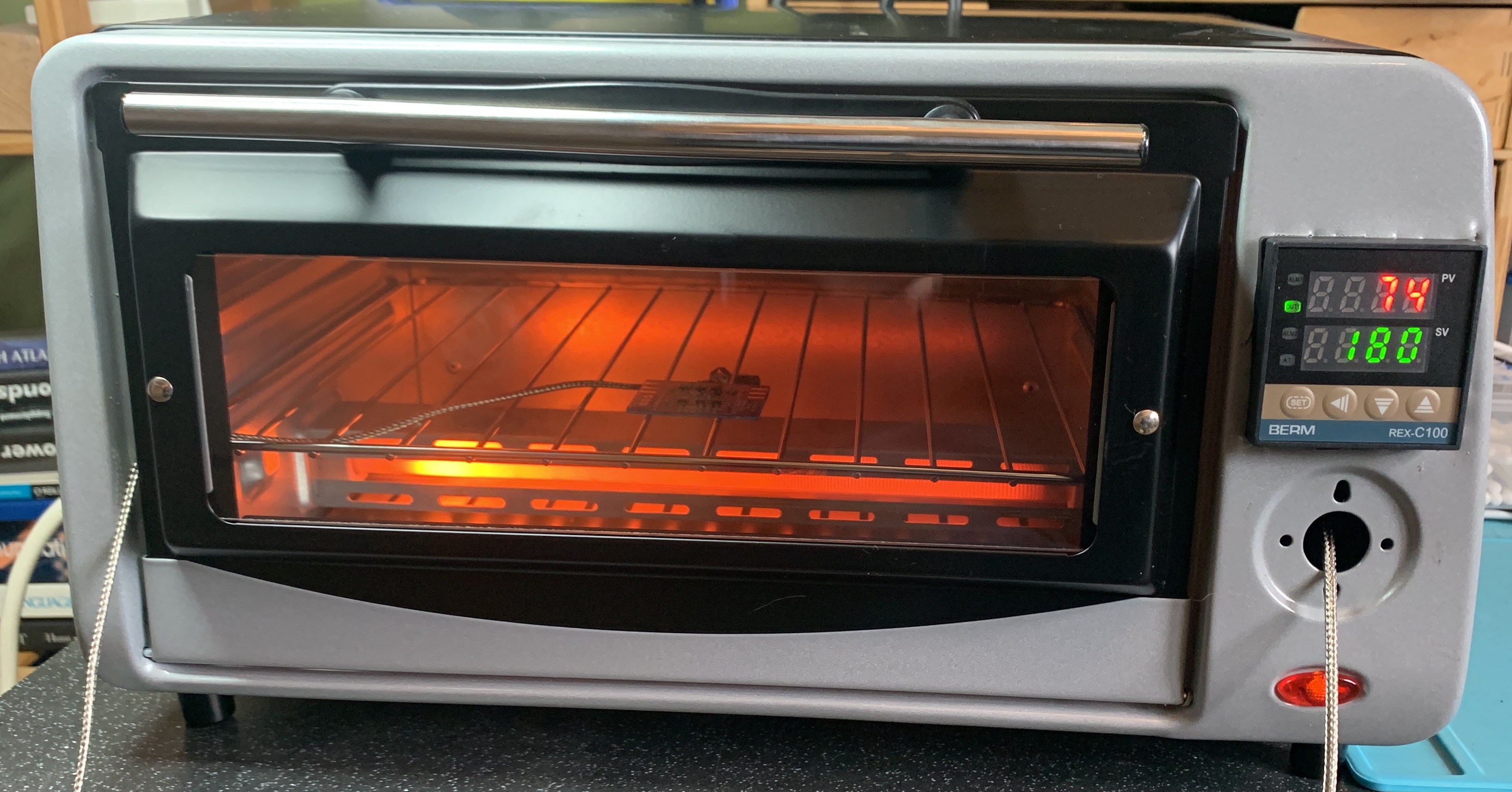 A modified toaster oven with a small PCB inside.