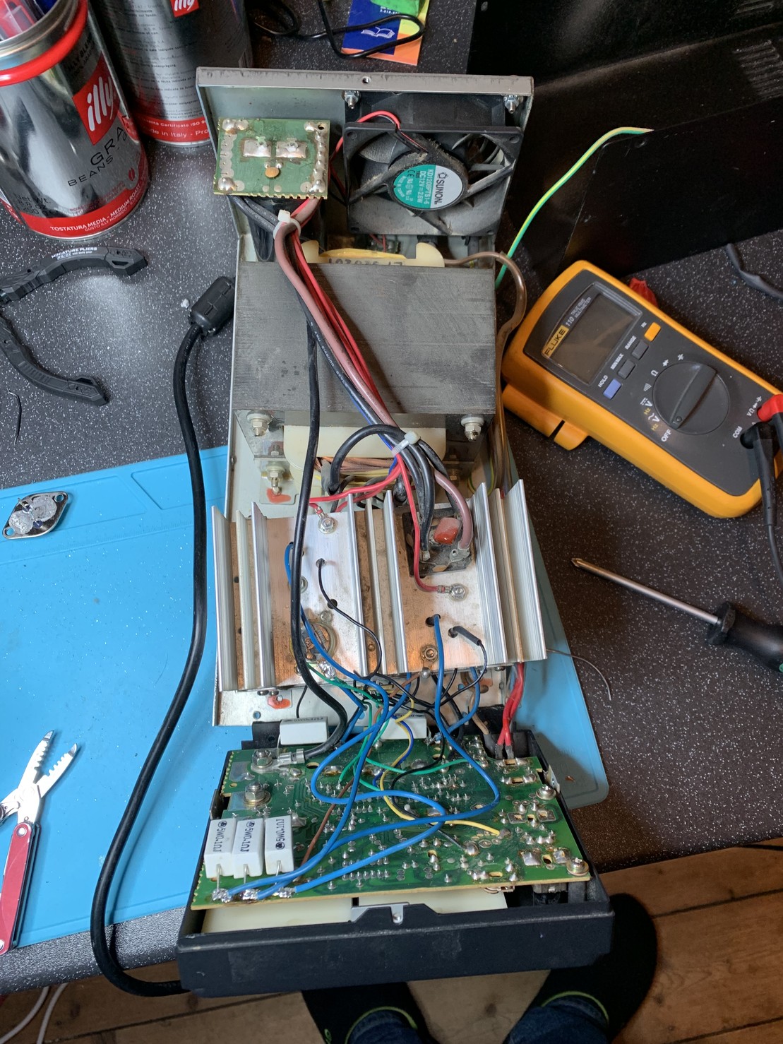 Inside a linear PSU. There’s a large transformer a large heat sink and a PCB