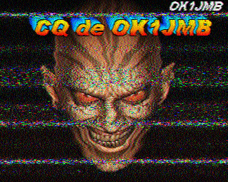 A scary looking face with evil eyes and a menacinh grin. Text across the top reads CQ de OK1JMB. This is an SSTV CQ call.